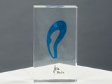 an image of a glass sculpture with a blue design on it