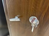 a close up of a door with a key on it