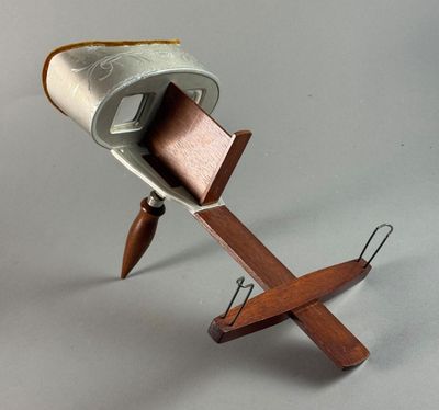 a wooden stand with a metal object on it