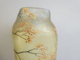 a glass vase with a tree on it on a table
