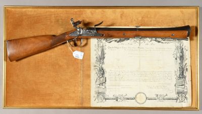 an old gun with a certificate in a case on a table