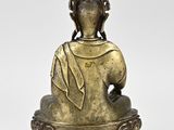 bronze statue of a seated buddha with a crown on his head