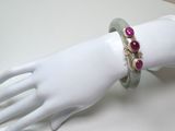 a white mannequin hand with a bracelet on it