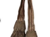 two tassels hanging on a hook on a white background