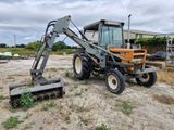a tractor that is parked in the dirt