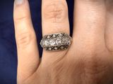 an image of a woman ' s hand with a diamond ring on it