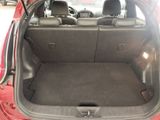 the back of a red car with its trunk open in a parking lot