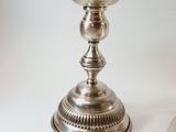 a silver candle that is sitting on a table