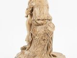 an image of a statue of a woman sitting on top of a tree stump