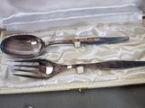 three forks and spoons in a case on a table