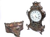 two clocks that are sitting next to each other on a table