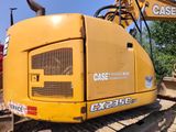 a yellow excavator that is sitting in the dirt