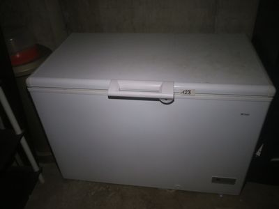 a small white chest freezer sitting in a room