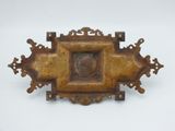 an old bronze plaque with a picture of a woman in a frame