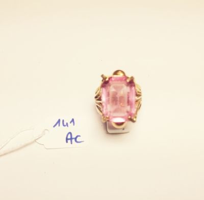 a close up of a ring with a pink stone in it
