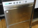 a stainless steel dishwasher sitting on a wooden floor