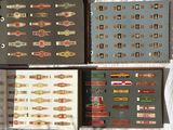 four boxes of cigars are lined up on a white sheet
