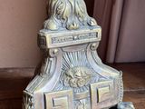 a metal candle holder sitting on a wooden table