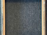 an empty wooden frame on a gray background