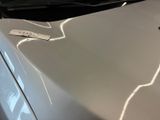 a sticker on the hood of a white car