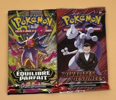 deux paquets de cartes à collectionner Pokémon posés sur une table