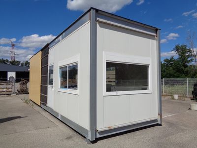 a small white building with a window in the middle of it