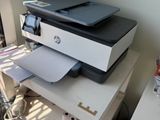 a printer that is sitting on top of a stack of boxes