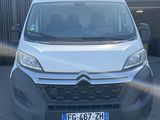 the front of a white van parked in a parking lot