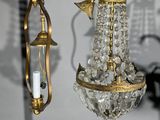 two chandeliers hanging from the ceiling in the room