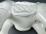 a white elephant figurine sitting on a table
