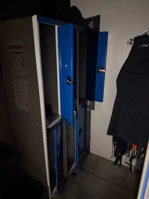 two blue lockers in the corner of a room