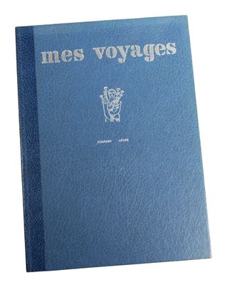 a blue book sitting on top of a table next to a white wall
