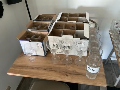 boxes of wine glasses on a table with empty wine glasses on it