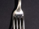 a fork that is sitting on top of a black table