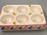 a white and pink box that has six eggs in it