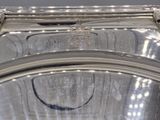 a close up of a silver plate on a table