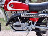a red and black motorcycle parked on the side of the road