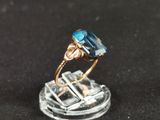 an image of a ring with a blue topaz stone on it