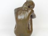 statue of a man with his head in his hands on a white background