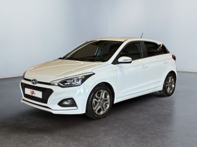 a white car is parked in a white room