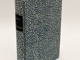 a blue and white book with a black cover on a white surface