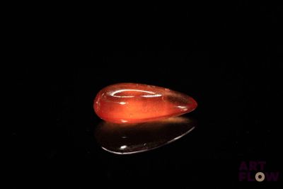 an image of a red stone on a black surface