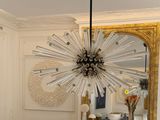 a dining room with a table and chairs and a mirror on the wall