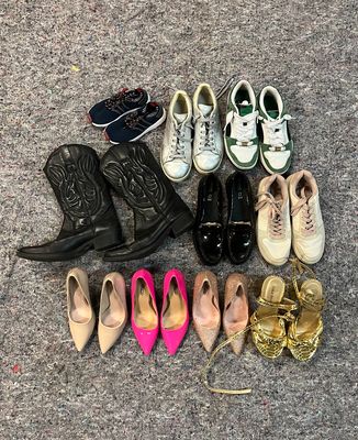 many pairs of shoes laid out on the ground