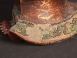 a close up of a hat on a black surface