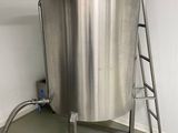 a large stainless steel tank with a ladder in the corner