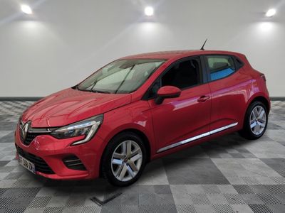 a red car parked in a garage with a checkered floor