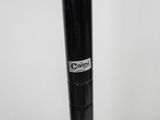 a close up of a black pole with a white sticker on it