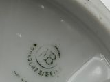 a close up of a white porcelain bowl with a black design on it