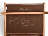 a brown chair with writing on the back of it